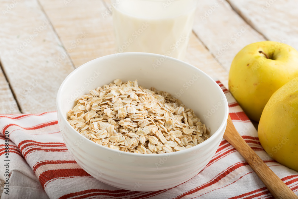 Oat flakes in bowl with apples and milk Oat flakes in bowl with apples and milk