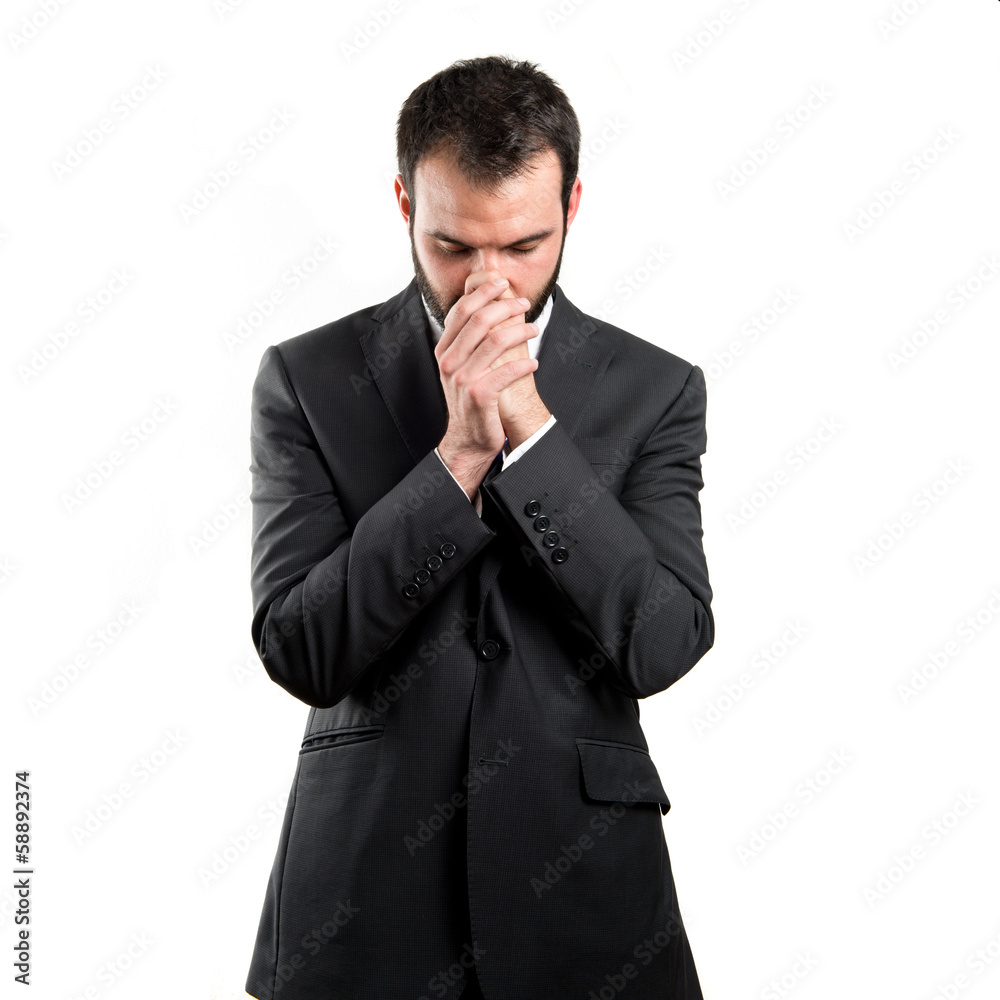 Young businessman pleading over white background Young businessman pleading over white background
