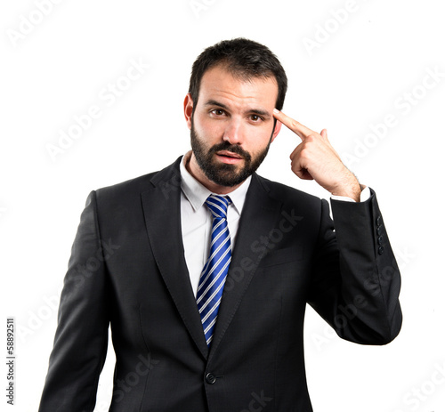 Businessman making a crazy gesture over white background