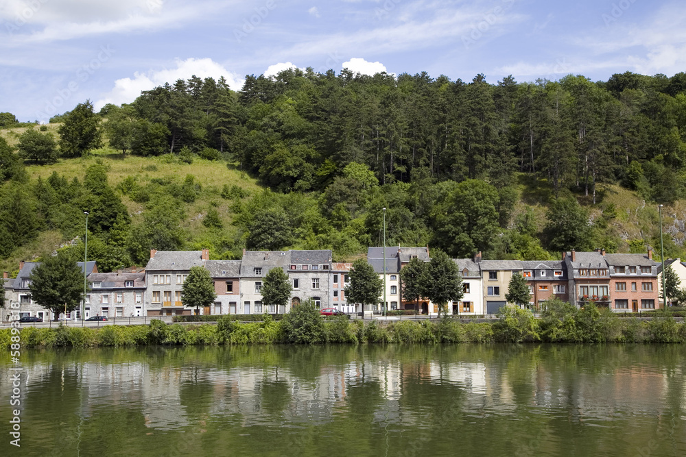 Small houses reflecting in river Meuse, Dinant, Belgium Small houses reflecting in river Meuse, Dinant, Belgium