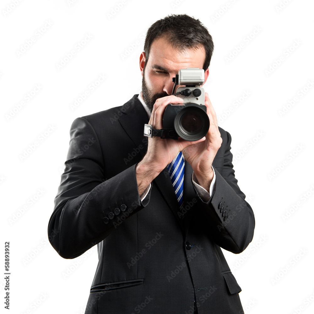 Young businessman recording video over white background Young businessman recording video over white background
