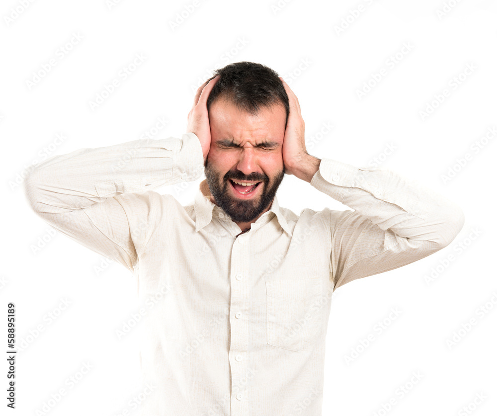 Young man with headache over white background Young man with headache over white background