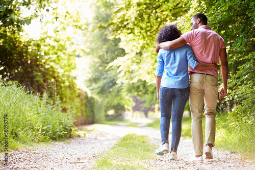 Young African American Couple Walking In Countryside