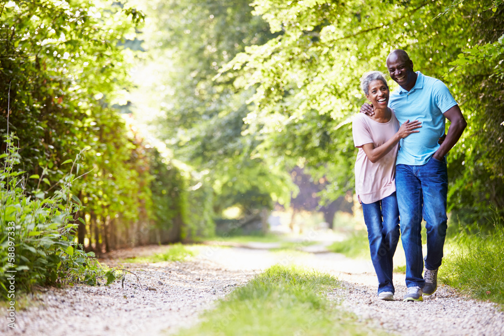 Mature African American Couple Walking In Countryside Mature African American Couple Walking In Countryside