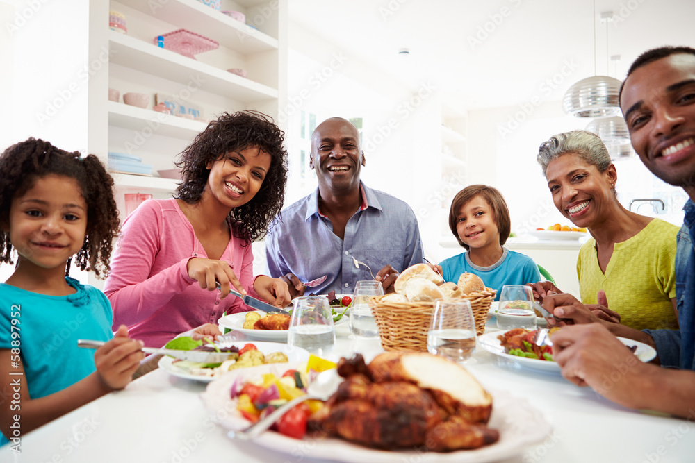 Multi Generation African American Family Eating Meal At Home