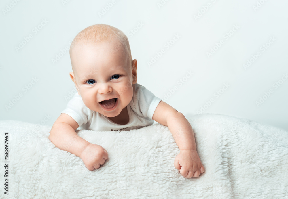 Little infant is smiling on the carpet Little infant is smiling on the carpet