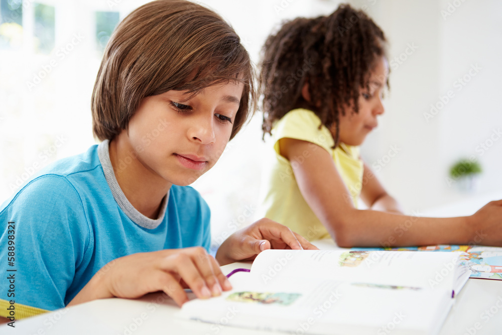 Children Doing Homework In Kitchen Together Children Doing Homework In Kitchen Together