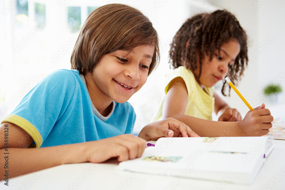 Children Doing Homework In Kitchen Together Children Doing Homework In Kitchen Together
