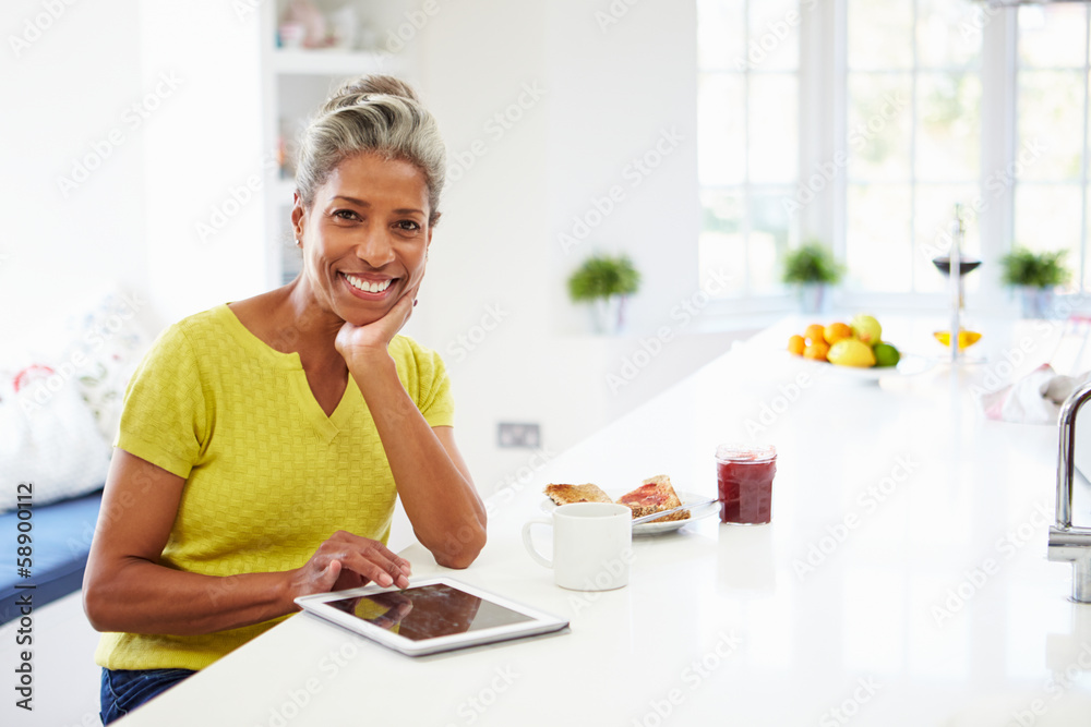 African American Woman Using Digital Tablet At Home
