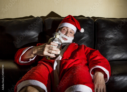 Slika na platnu drunk Santa Claus posing with a bottle of whisky