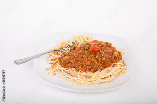 A plate of traditional spaghetti bolognese on a white counter