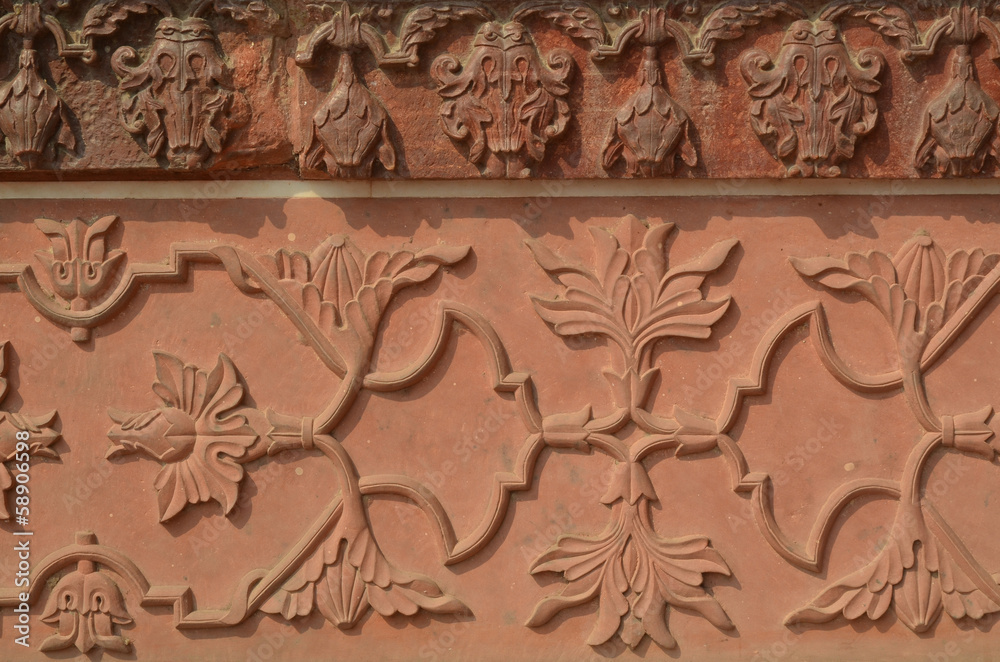 Wall of Taj Mahal with intricate patterns in red sand stone