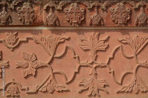 Wall of Taj Mahal with intricate patterns in red sand stone