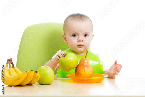 baby eating healthy solid f...
