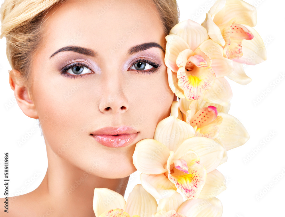 woman with healthy skin and flowers close to face woman with healthy skin and flowers close to face