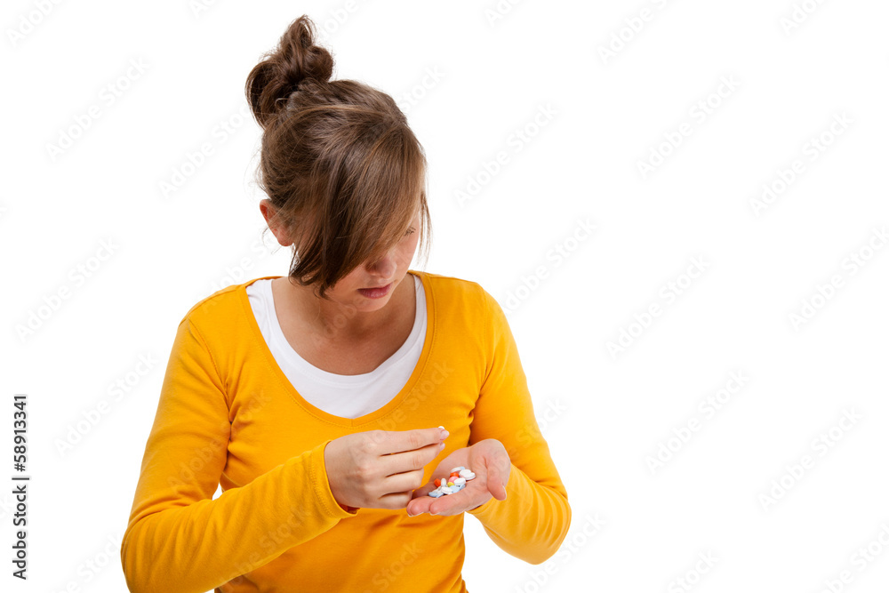 Headache - woman holding pills isolated on white background Headache - woman holding pills isolated on white background