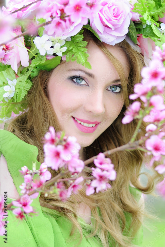 Beautiful girl in a flowered garden peach Beautiful girl in a flowered garden peach