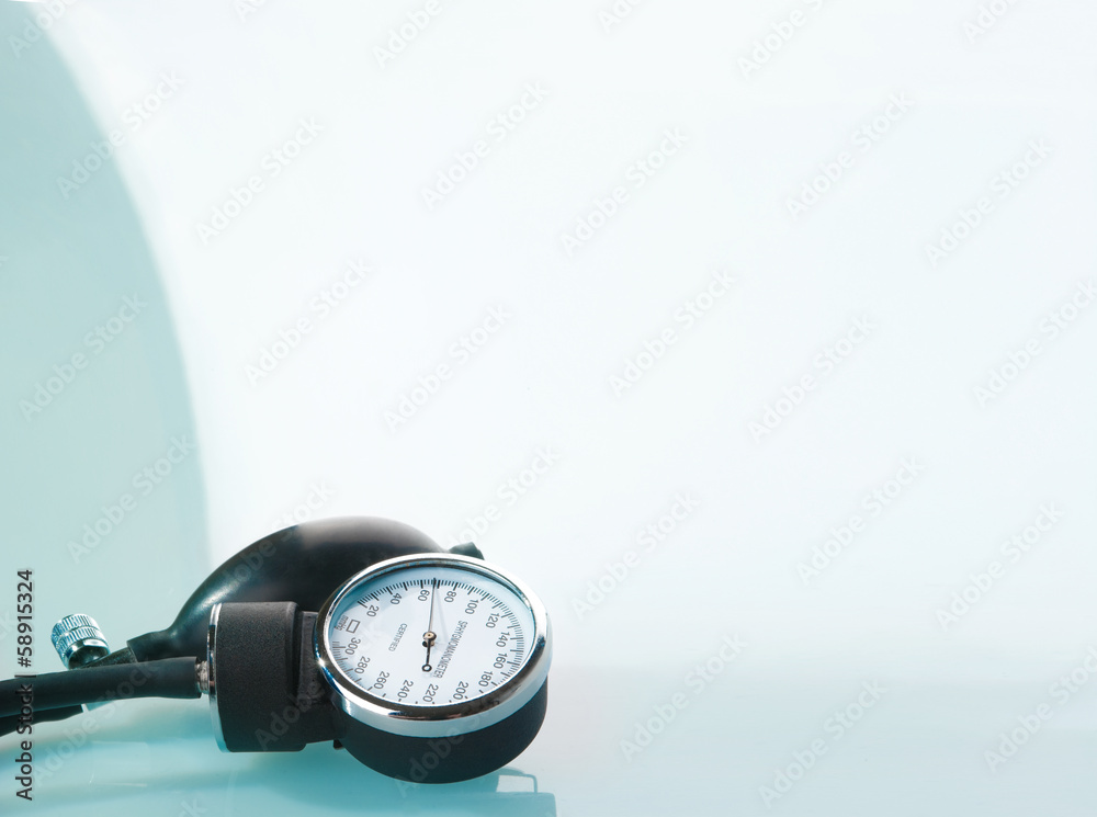 Sphygmomanometer on blue, reflective background