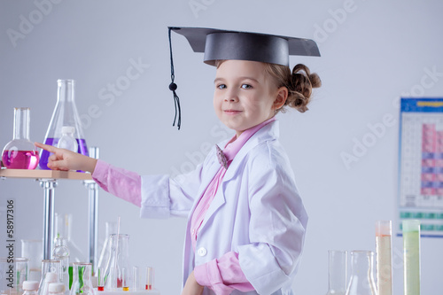 Cute little laboratorian posing in graduate hat photo