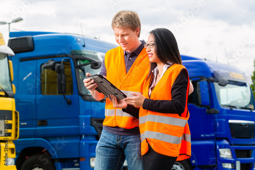 Forwarder in front of trucks on a depot