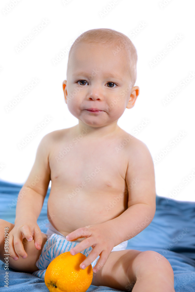 cute one year baby boy holding a orange cute one year baby boy holding a orange