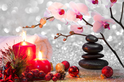 massage composition christmas spa with candles, orchid, stones