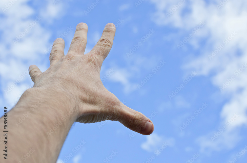 hand stretched to the blue cloudy sky hand stretched to the blue cloudy sky