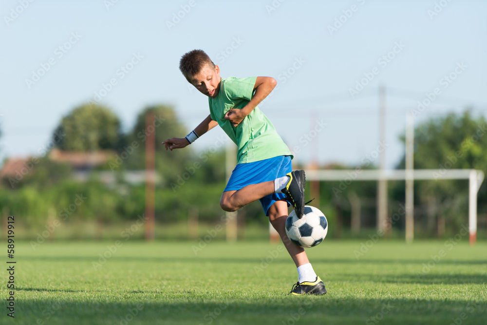 Fototapeta premium little boy running dribbling