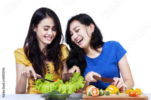 Two friend prepare salad