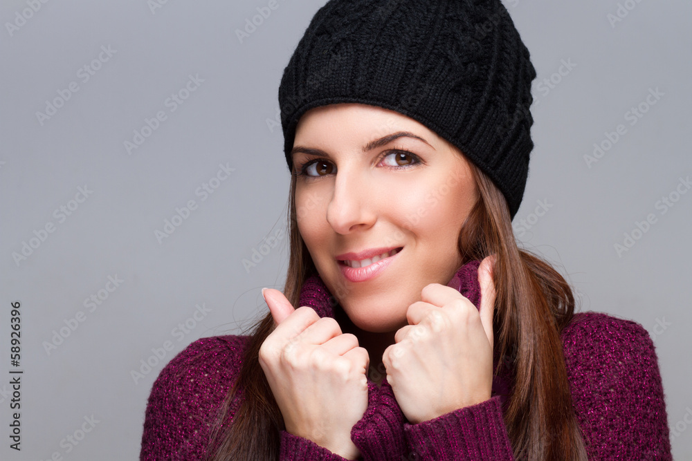 young woman wearing cap and smiling on light background young woman wearing cap and smiling on light background