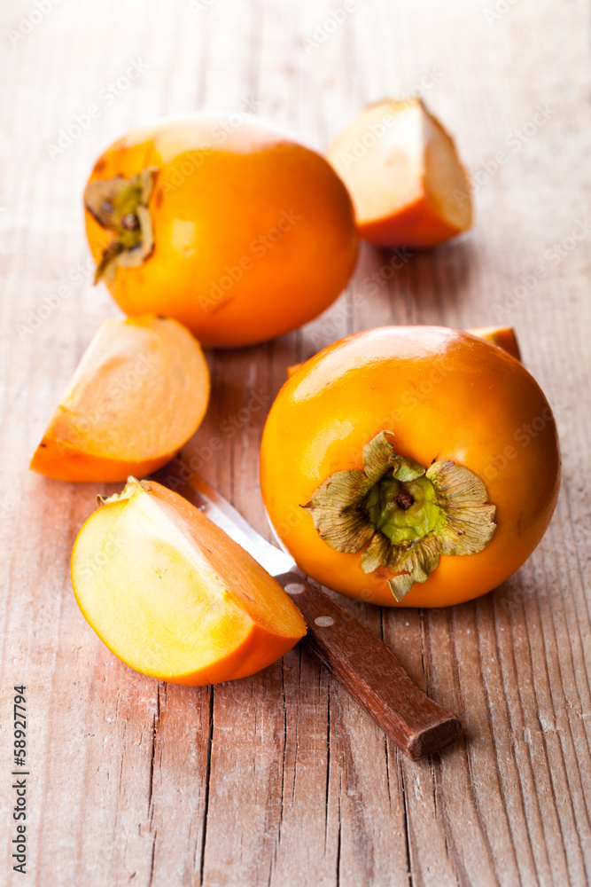 fresh sliced persimmons and knife