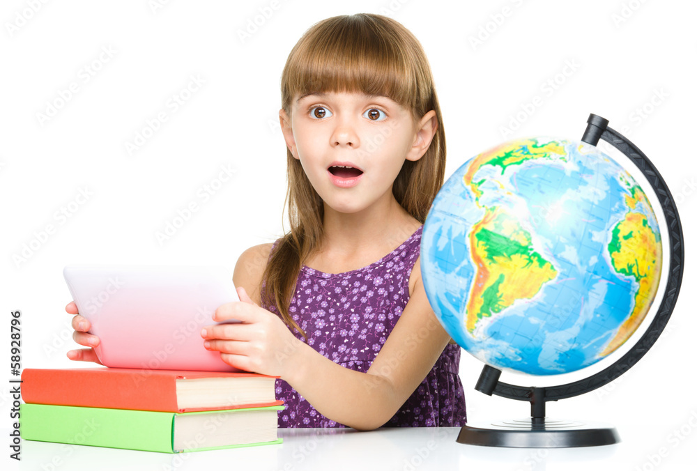 Young girl is using tablet while studying Young girl is using tablet while studying