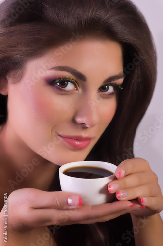 Beautiful woman with coffee cup. Fashion portrait