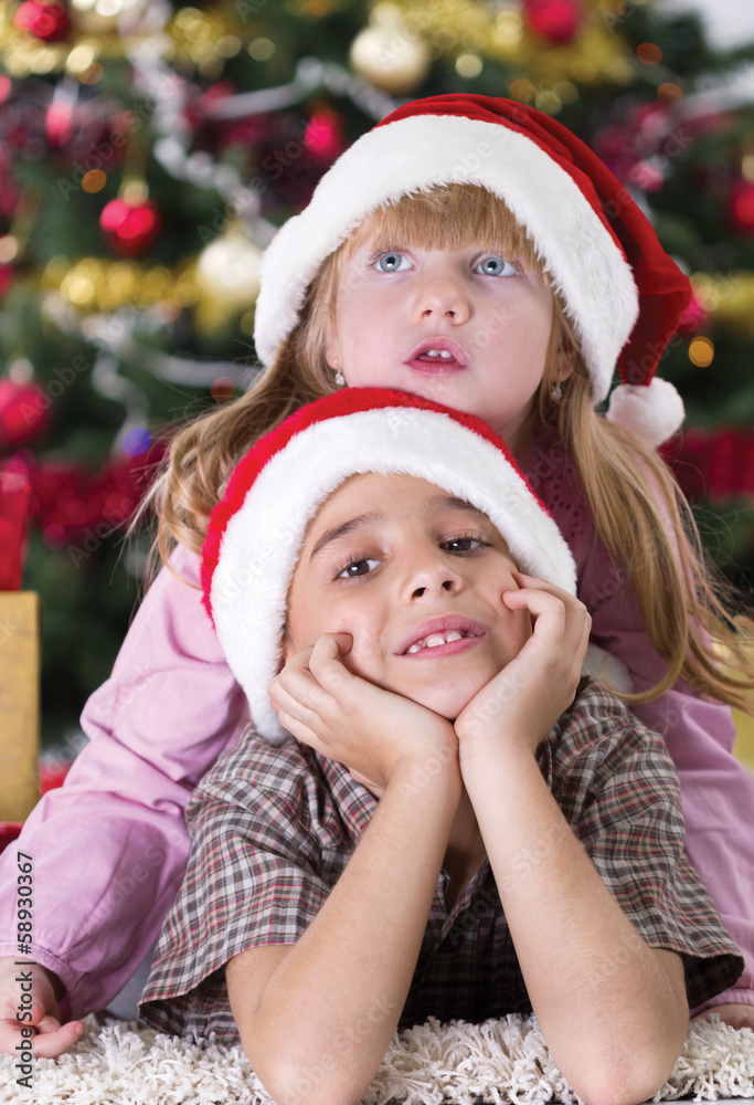 Portrait of happy boy laughing in his sister embrace on Christma Portrait of happy boy laughing in his sister embrace on Christma