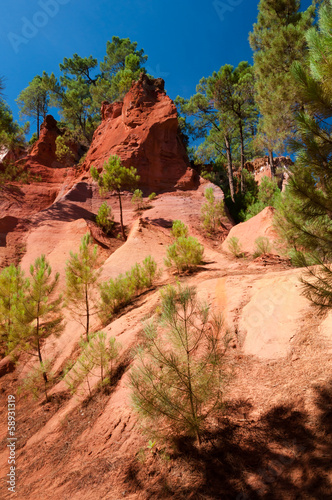 Red rock formations and trees on Le Sentier des Ocres in Roussil