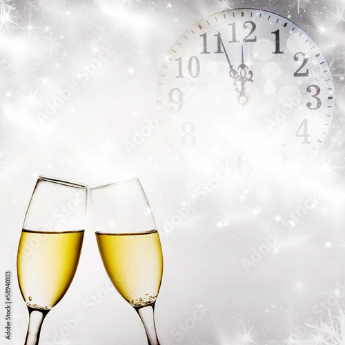 Champagne glasses and clock at midnight