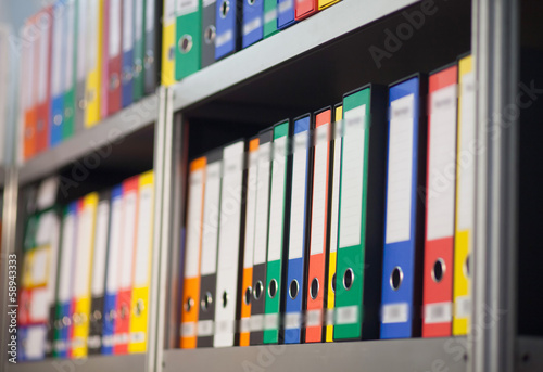 colorful folders on bookshelf photo