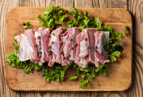 Raw pork ribs on a cutting board photo