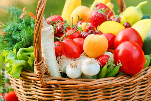 Organic fruits and vegetables in a wicker basket