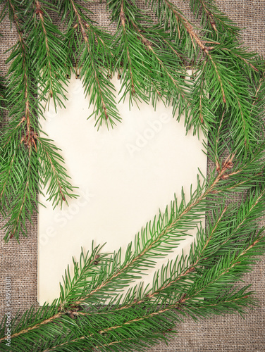 Christmas card with notebook and fir branch on burlap
