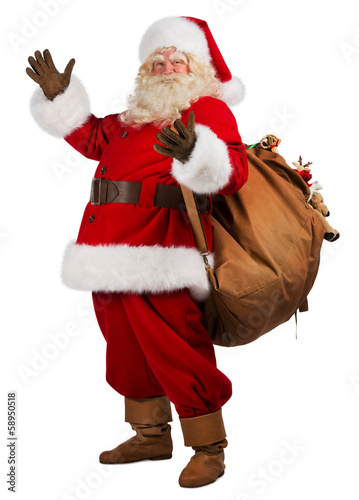 Real Santa Claus carrying big bag full of gifts, isolated on whi