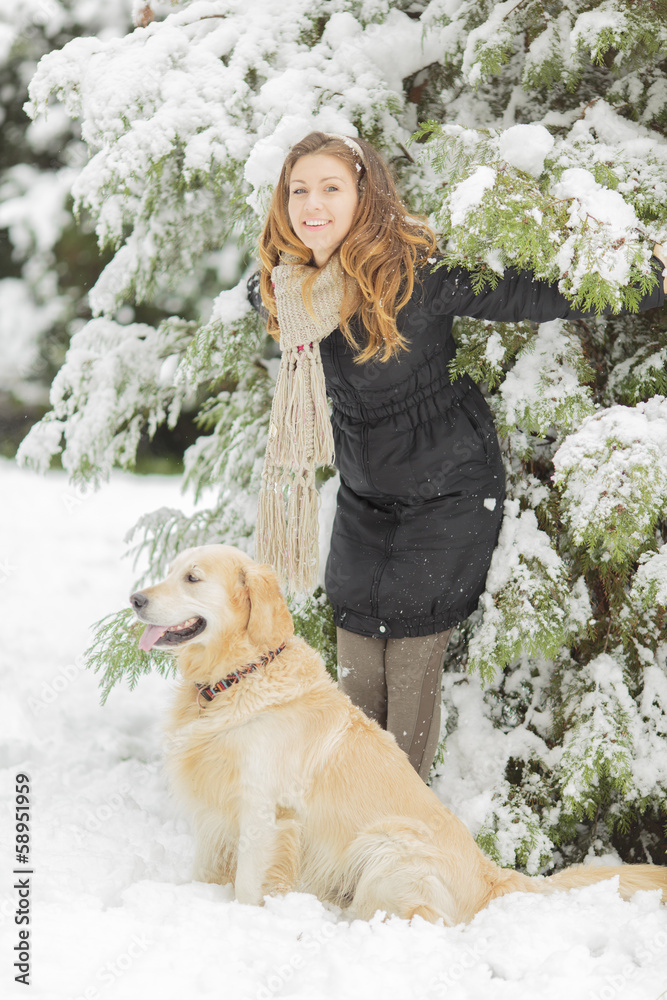 Young woman with dog at winter