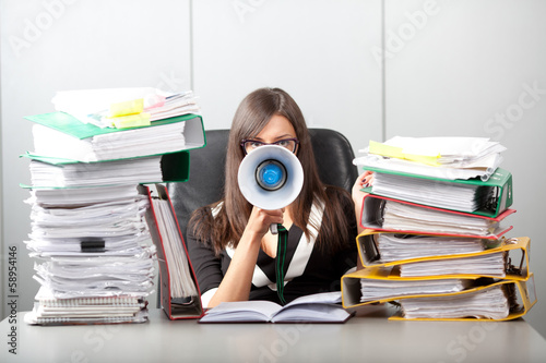 Business woman screaming with a megaphone