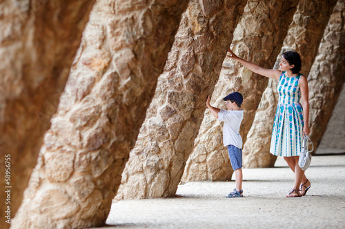 Young mother and her son walking Park Guell