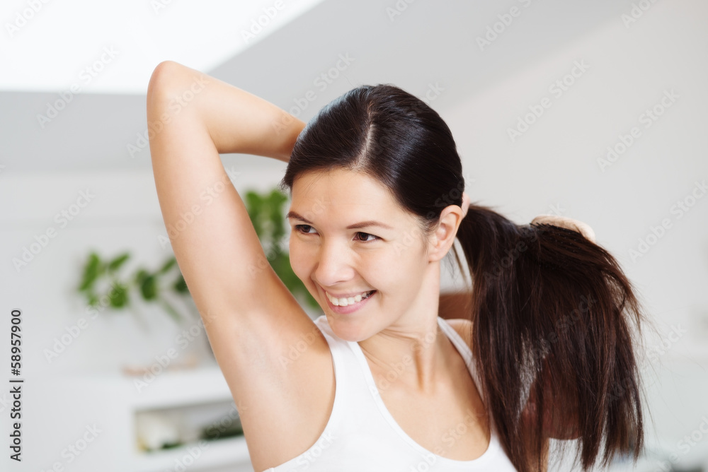 Smiling woman brushing her hair