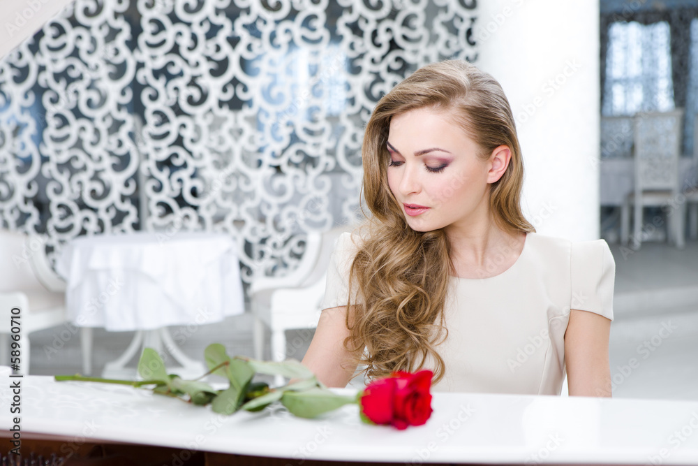 Portrait of woman with red rose playing piano Portrait of woman with red rose playing piano