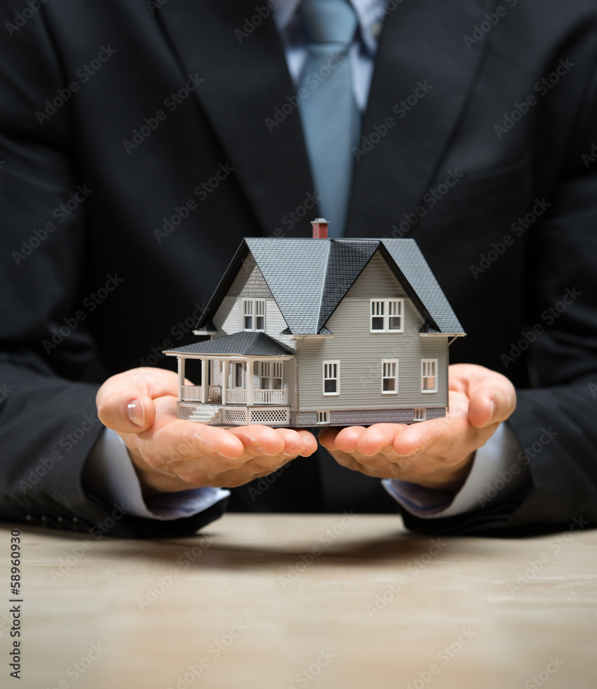 Close up of hands with little home. Concept of deal Close up of hands with little home. Concept of deal
