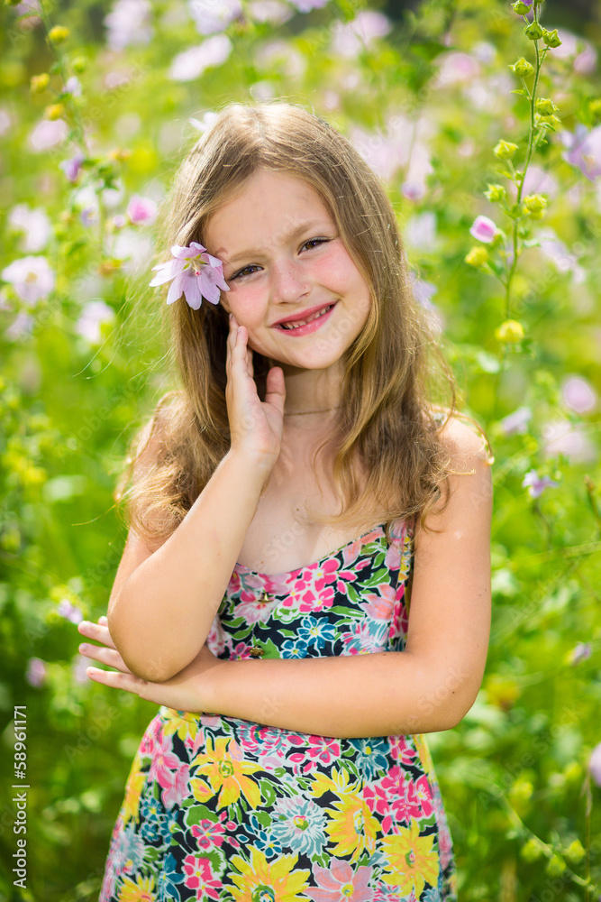 Portrait of a little girl in wreath of flowers
