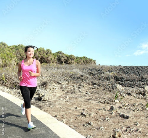 beautiful girl jogging on jogging track