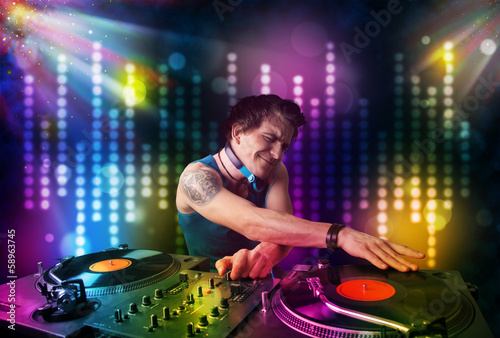 Dj playing songs in a disco with light show © ra2 studio